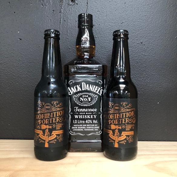 Two bottles of Liberty Prohibition Porter flanking a 1 Litre bottle of Jack Daniels Tennessee Whiskey.